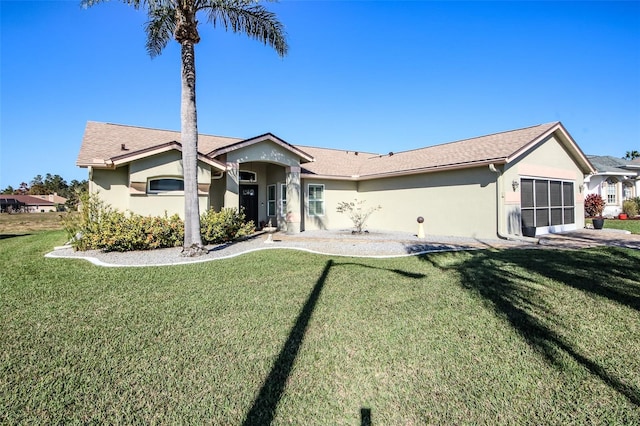 ranch-style home featuring stucco siding and a front lawn