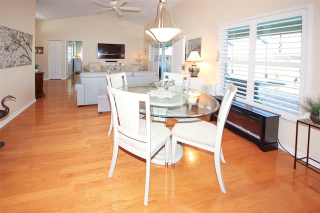 dining space with lofted ceiling, light wood-style flooring, baseboards, and ceiling fan