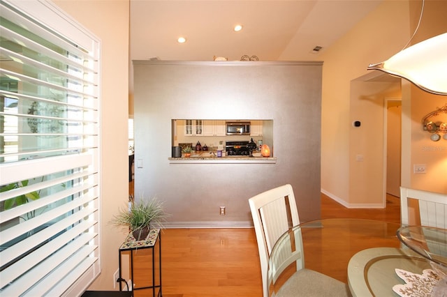 dining space with visible vents, recessed lighting, baseboards, and wood finished floors