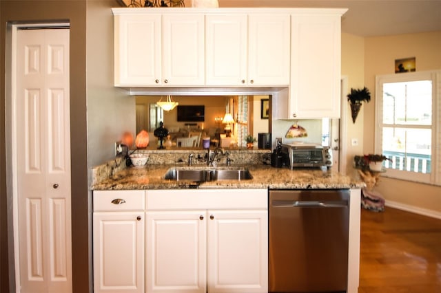 kitchen featuring a sink, light stone countertops, stainless steel dishwasher, and white cabinetry