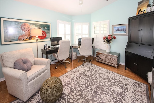 office area with baseboards and wood finished floors