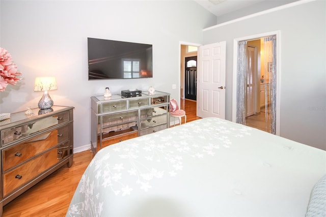 bedroom featuring baseboards and light wood-type flooring