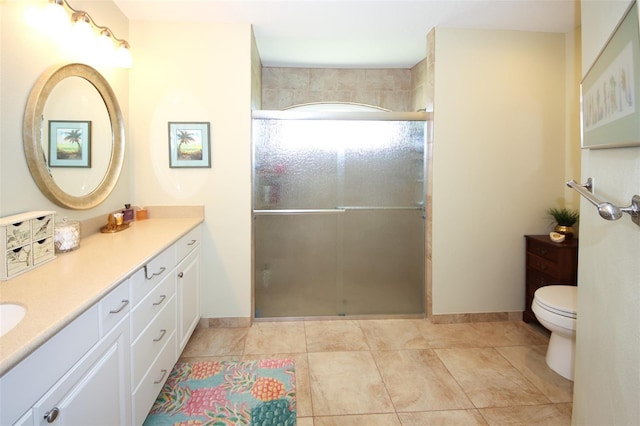 full bathroom with vanity, toilet, baseboards, and a stall shower