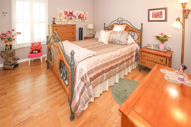 bedroom with baseboards and light wood-type flooring