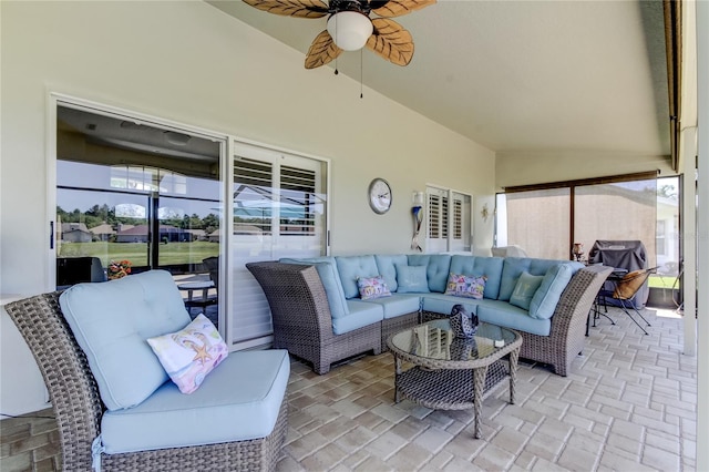 sunroom with ceiling fan and vaulted ceiling