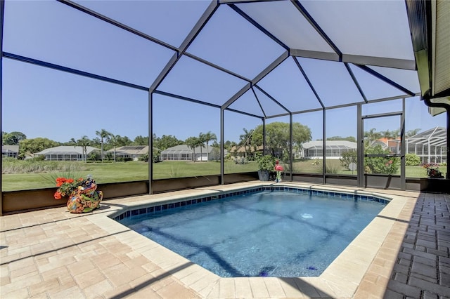 view of swimming pool featuring a patio and a lanai