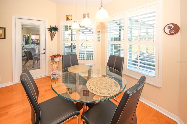 8609 Regal Ln, Hudson, FL 34667 - dining space featuring baseboards and light wood-style flooring