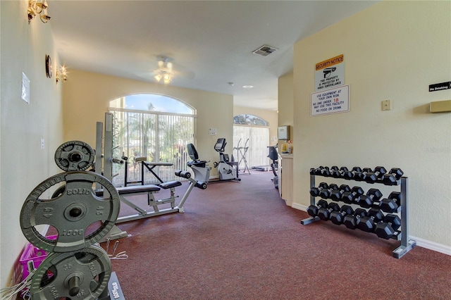 8609 Regal Ln, Hudson, FL 34667 - exercise room with visible vents, a ceiling fan, baseboards, and carpet flooring