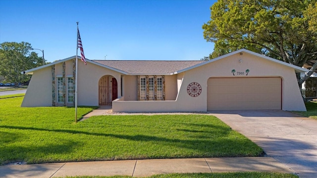 view of front of house featuring stucco siding, french doors, concrete driveway, a front yard, and an attached garage