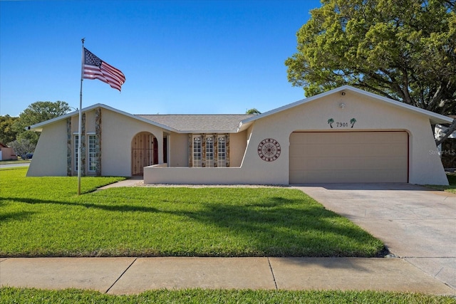 view of front of property with stucco siding, an attached garage, concrete driveway, and a front yard