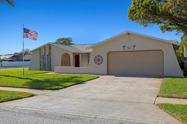 ranch-style house with stucco siding, concrete driveway, a front yard, and a garage