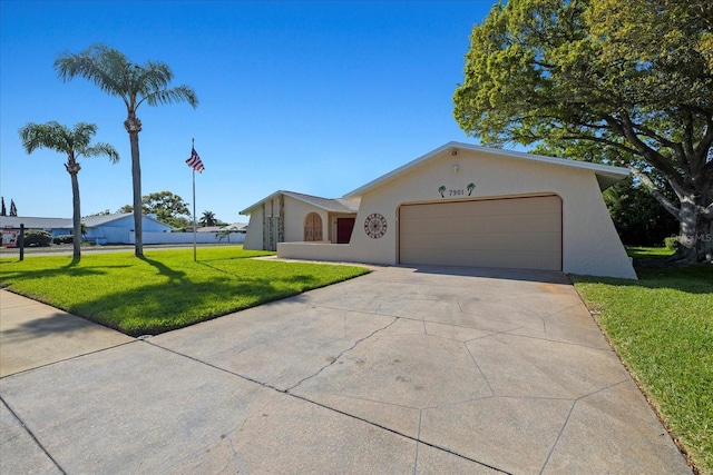 ranch-style home featuring a front lawn, concrete driveway, a garage, and stucco siding