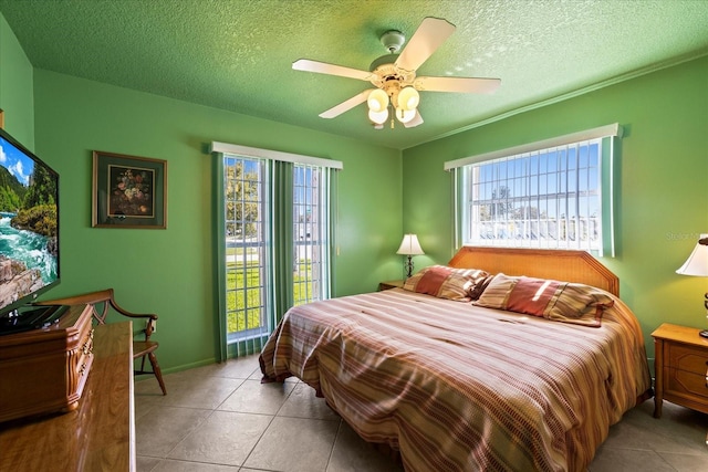 bedroom featuring tile patterned floors, a textured ceiling, and a ceiling fan