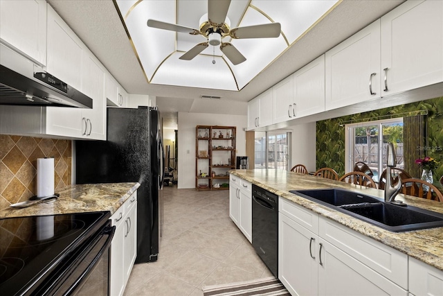 kitchen with black appliances, a ceiling fan, tasteful backsplash, white cabinetry, and a raised ceiling