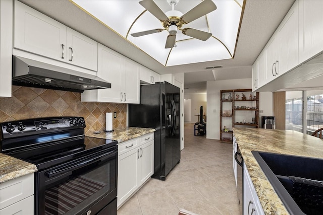 kitchen featuring a ceiling fan, light tile patterned flooring, decorative backsplash, black appliances, and under cabinet range hood