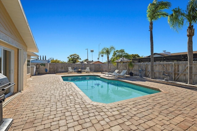 view of swimming pool with a patio, a fenced backyard, and a fenced in pool