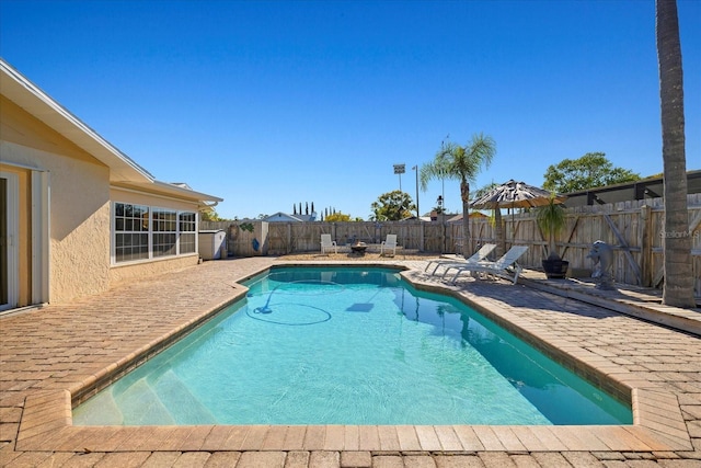 view of pool with a fenced in pool, a fenced backyard, and a patio area