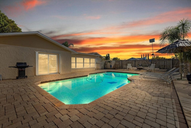 view of pool featuring a fenced backyard, grilling area, a fenced in pool, and a patio