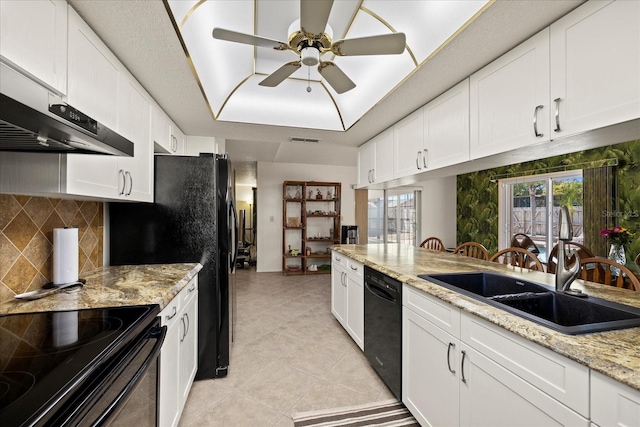 7901 Willow Brook Ct, Hudson, FL 34667 - kitchen with black appliances, ceiling fan, white cabinets, and backsplash