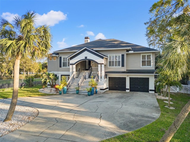 view of front of house featuring fence, stairway, a front yard, a garage, and driveway