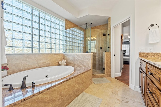 ensuite bathroom with vanity, ensuite bath, a stall shower, tile patterned floors, and a bath