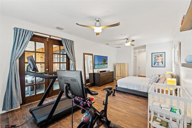 bedroom with visible vents, french doors, and wood finished floors