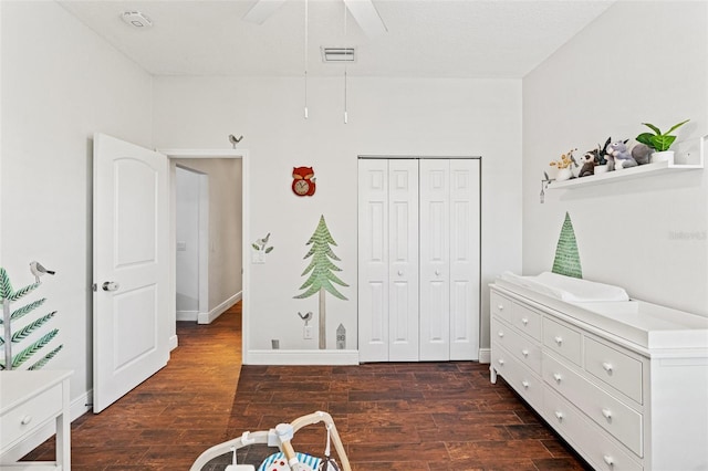 bedroom with visible vents, a ceiling fan, a closet, and dark wood-style flooring