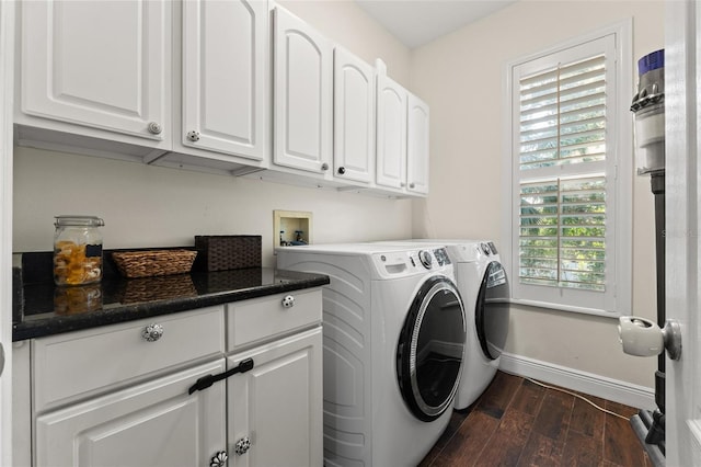 laundry area with washing machine and clothes dryer, dark wood-style floors, cabinet space, and baseboards