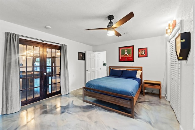 bedroom with concrete floors, baseboards, french doors, a textured ceiling, and access to outside