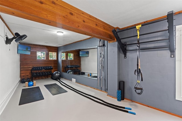 workout room featuring concrete block wall