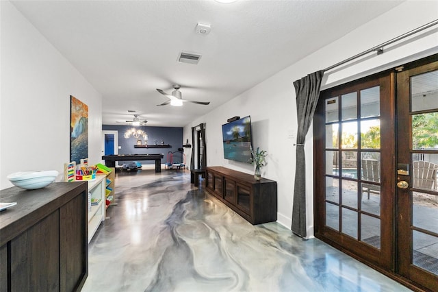 living room with visible vents, french doors, pool table, and finished concrete floors