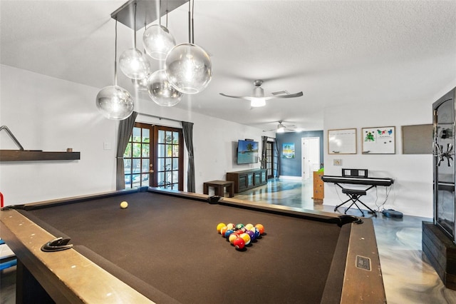 recreation room featuring french doors, a textured ceiling, pool table, and finished concrete flooring