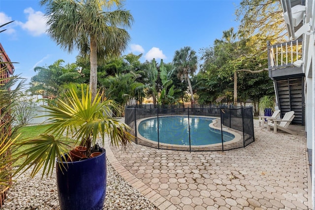 view of pool with a fenced in pool, fence, and a patio area