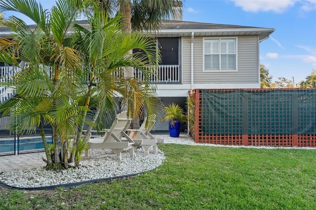 rear view of house featuring a lawn