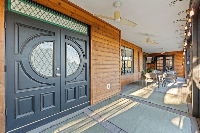 view of exterior entry with french doors and ceiling fan