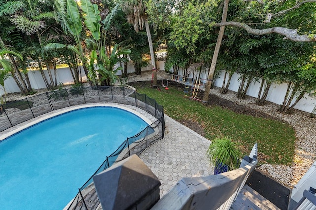 view of pool featuring a patio, a fenced backyard, and a fenced in pool