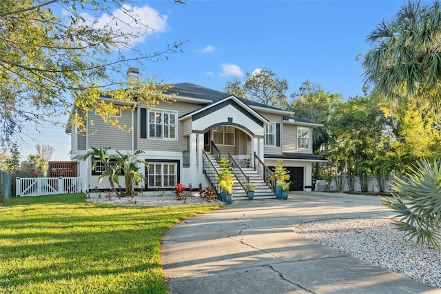 view of front of property featuring a front lawn, fence, concrete driveway, an attached garage, and a chimney