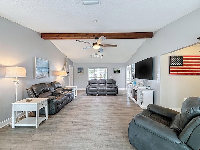 living room with ceiling fan, baseboards, lofted ceiling with beams, wood finished floors, and a textured ceiling