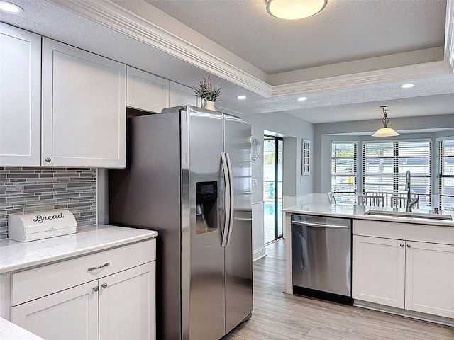 kitchen featuring a sink, stainless steel appliances, and white cabinets