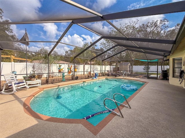 view of swimming pool with a lanai, a fenced in pool, a patio, and a fenced backyard