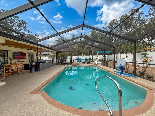 view of pool featuring a patio area, a fenced in pool, glass enclosure, and a fenced backyard