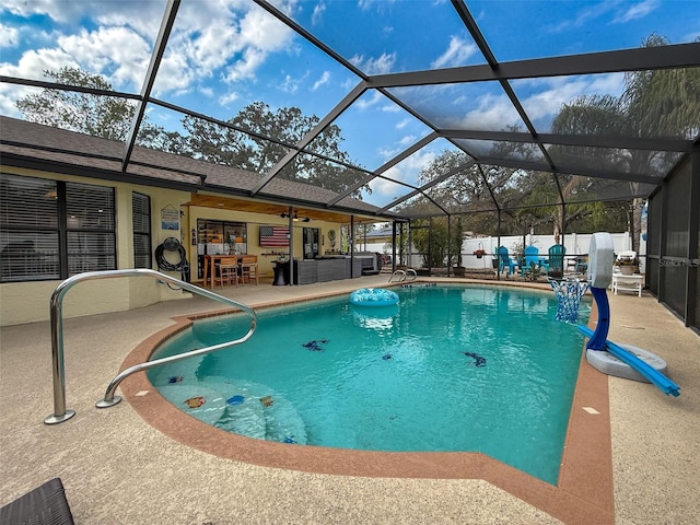 view of swimming pool featuring a fenced in pool, fence, a lanai, and a patio area