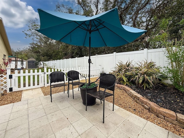 view of patio / terrace featuring an outbuilding and a fenced backyard