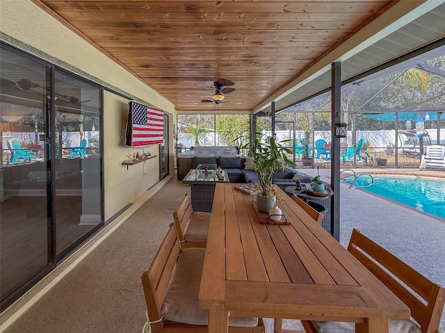 sunroom featuring wood ceiling and ceiling fan