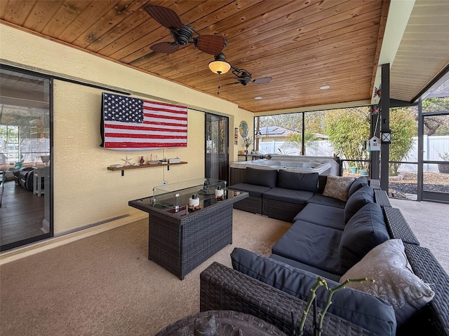 living area featuring wood ceiling, carpet, and a textured wall