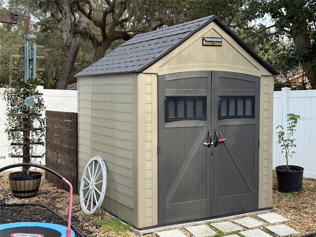 view of shed with fence