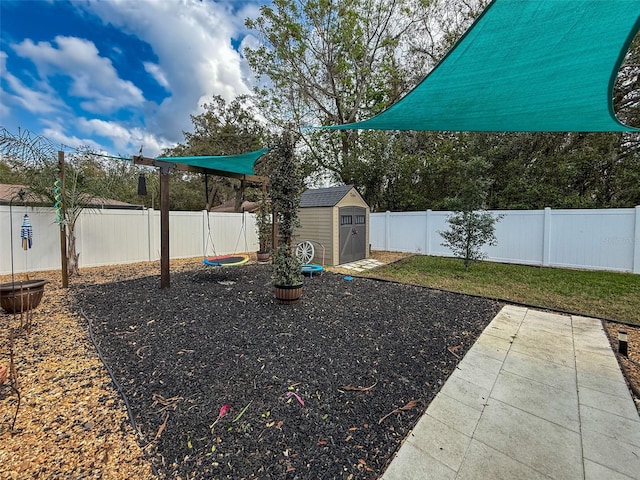 view of yard with a fenced backyard, a storage shed, and an outdoor structure