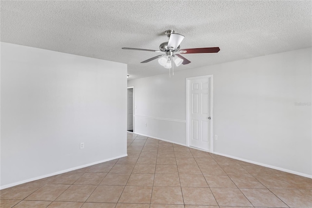 spare room featuring a textured ceiling, baseboards, and ceiling fan