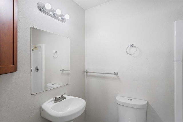 bathroom featuring toilet and a sink