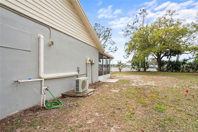 view of yard with ac unit and a sunroom